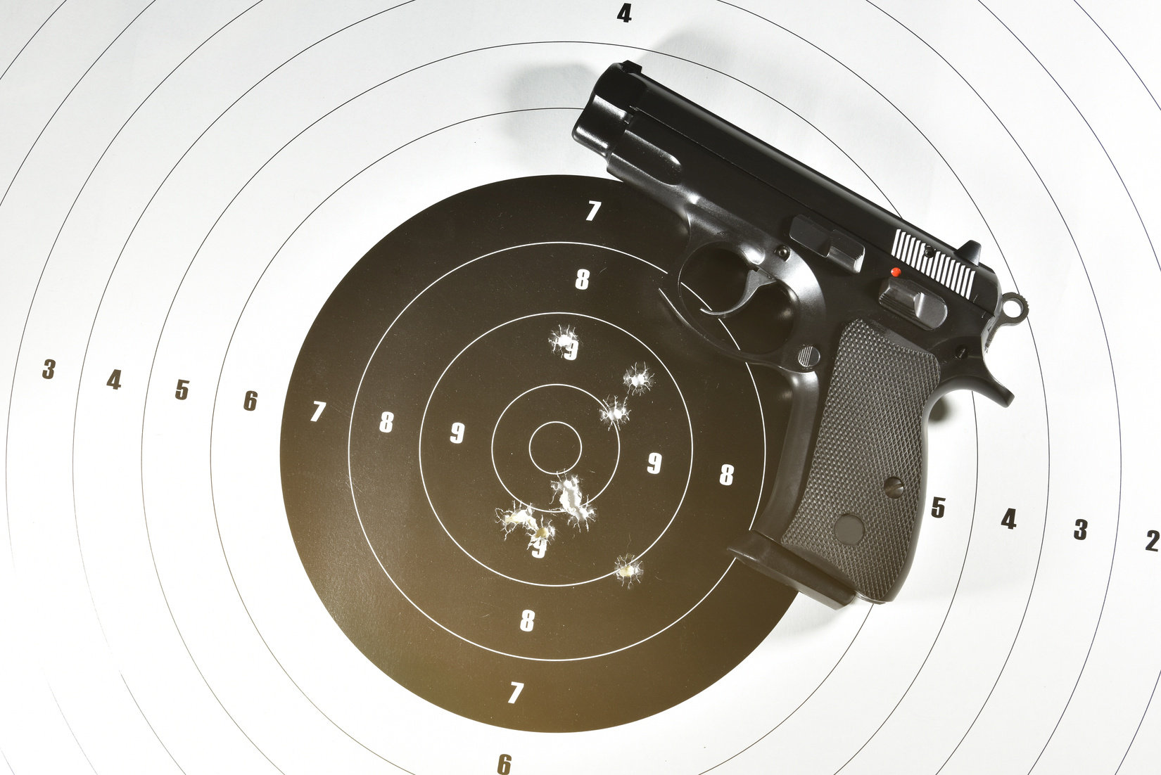 Handgun and Shooting Target Flatlay